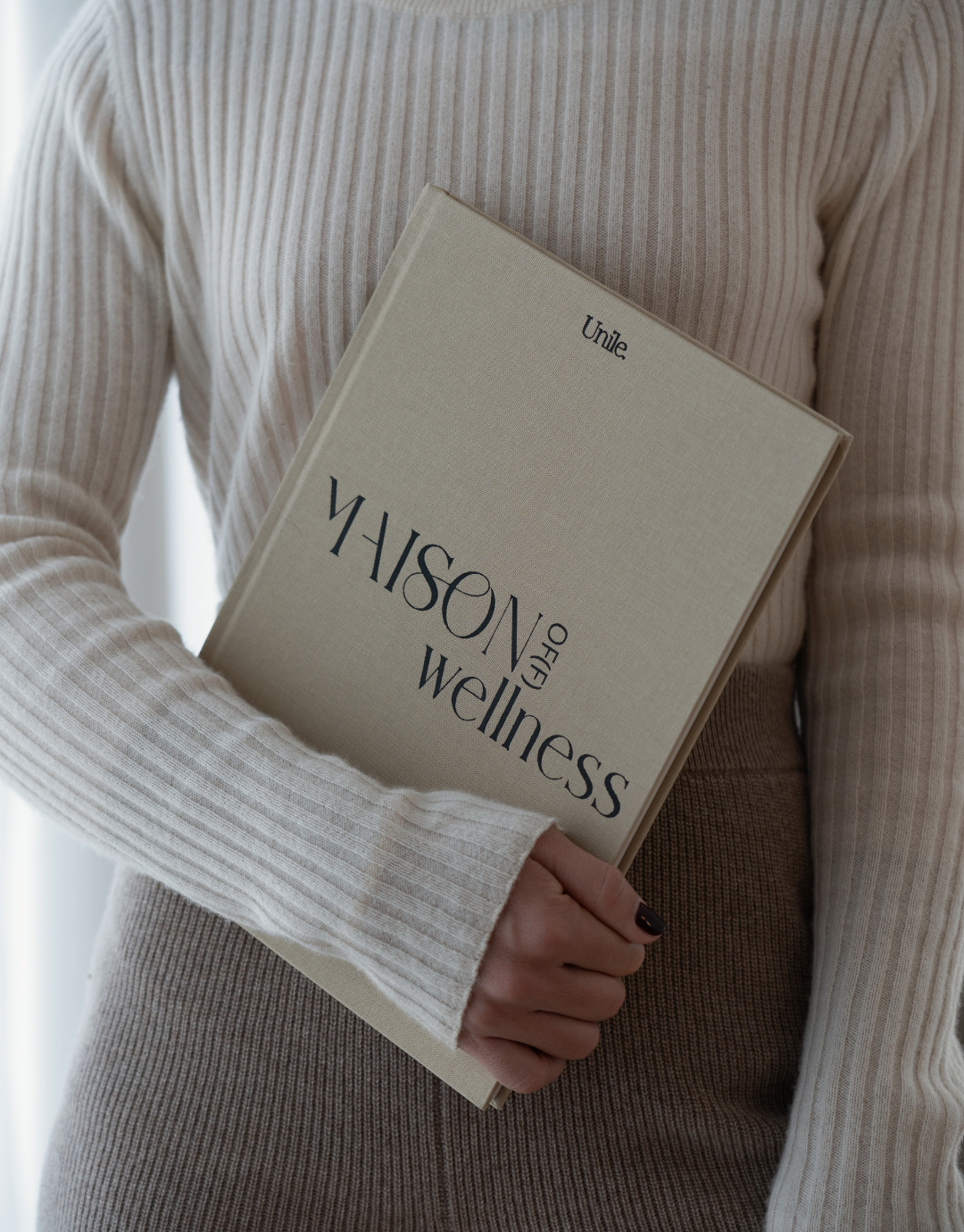 Le book Unile x Maison Of(f) Wellness dans les mains de Laure Dary.